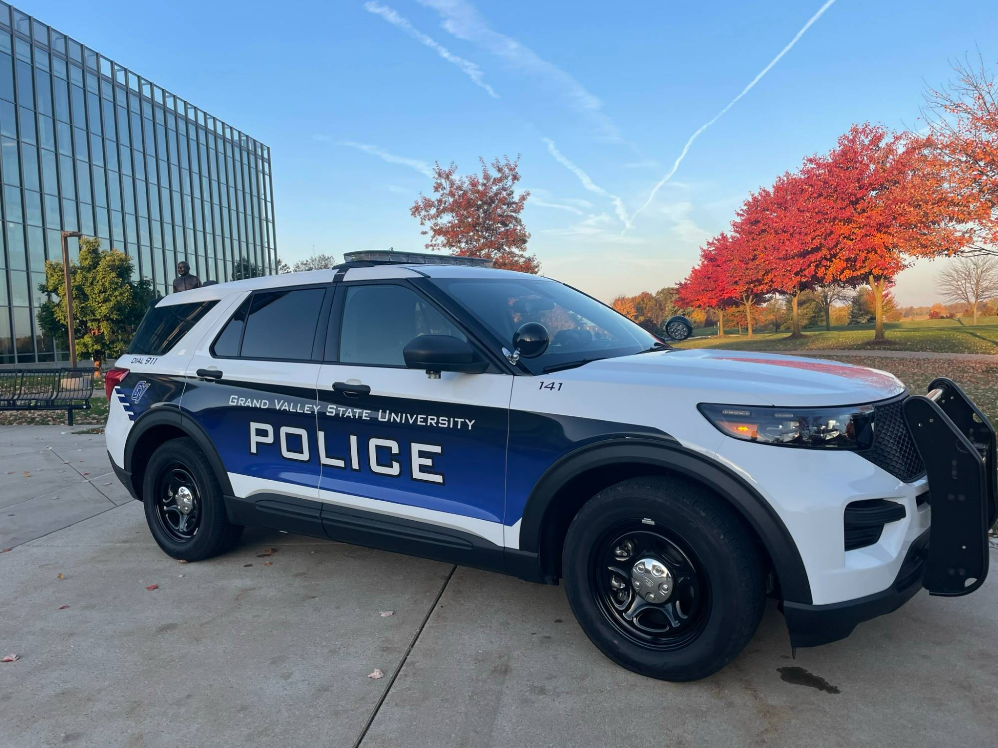 Police cruiser with fall colored trees in the background